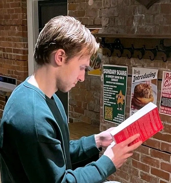Standing reading a book